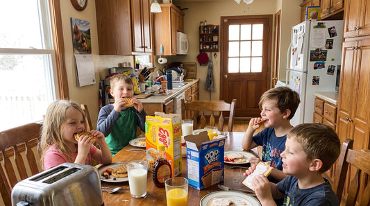 Children eating breakfast together at a family table